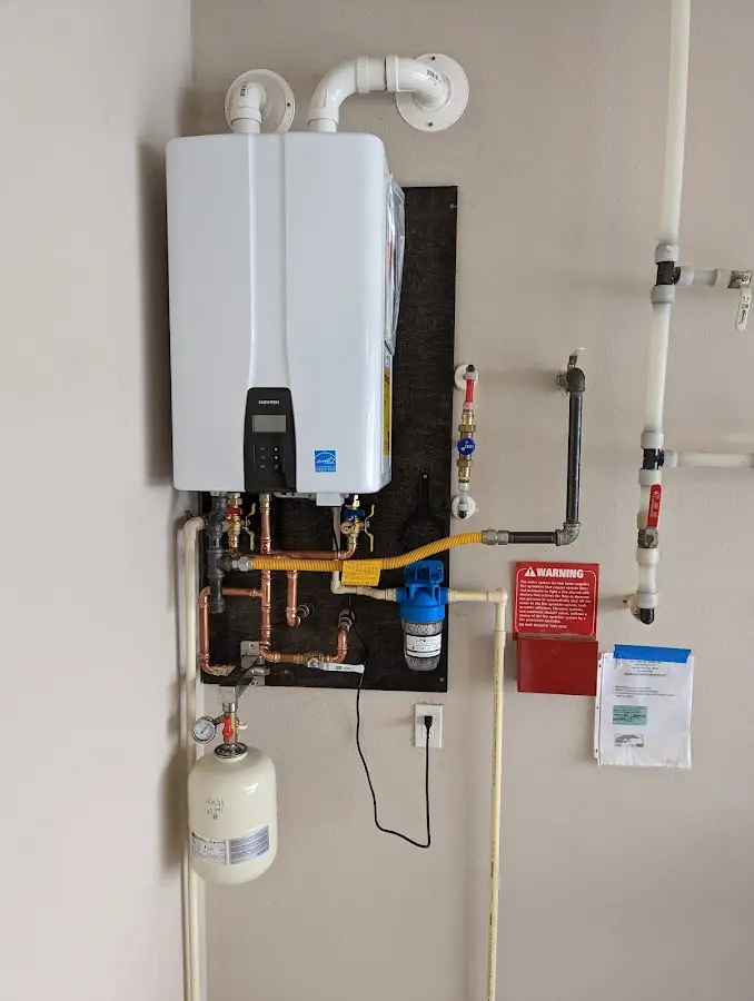 Professional plumber installing copper piping in a Fort Oglethorpe home